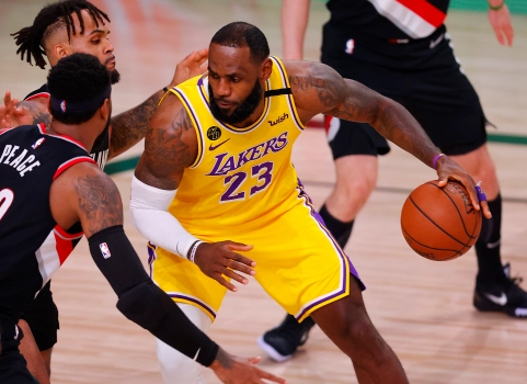 LeBron James (23) being contested by two Portland Trail Blazers in Game 1 of the 2020 NBA Playoffs.