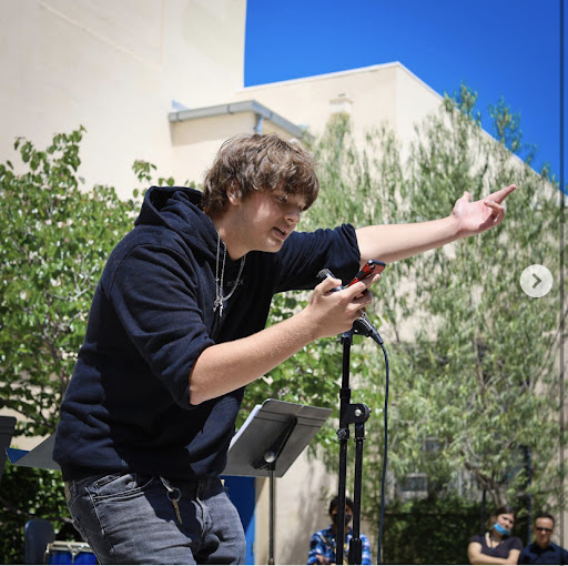 Kaleb performing his poem for the audience at the poetry slam.