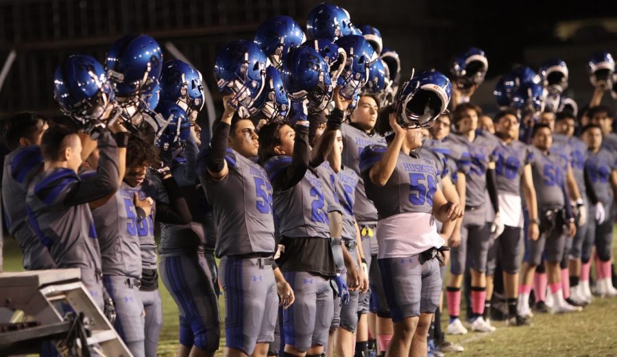 The+North+Hollywood+Huskies+raise+their+helmets+for+the+Pledge+of+Allegiance.+Photo+courtesy+of+Mr.+Chavez