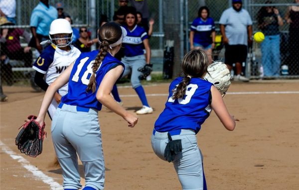 Kelsey Brinkle (#18) and Judith Arrendondo (#19) securing an out at first base.