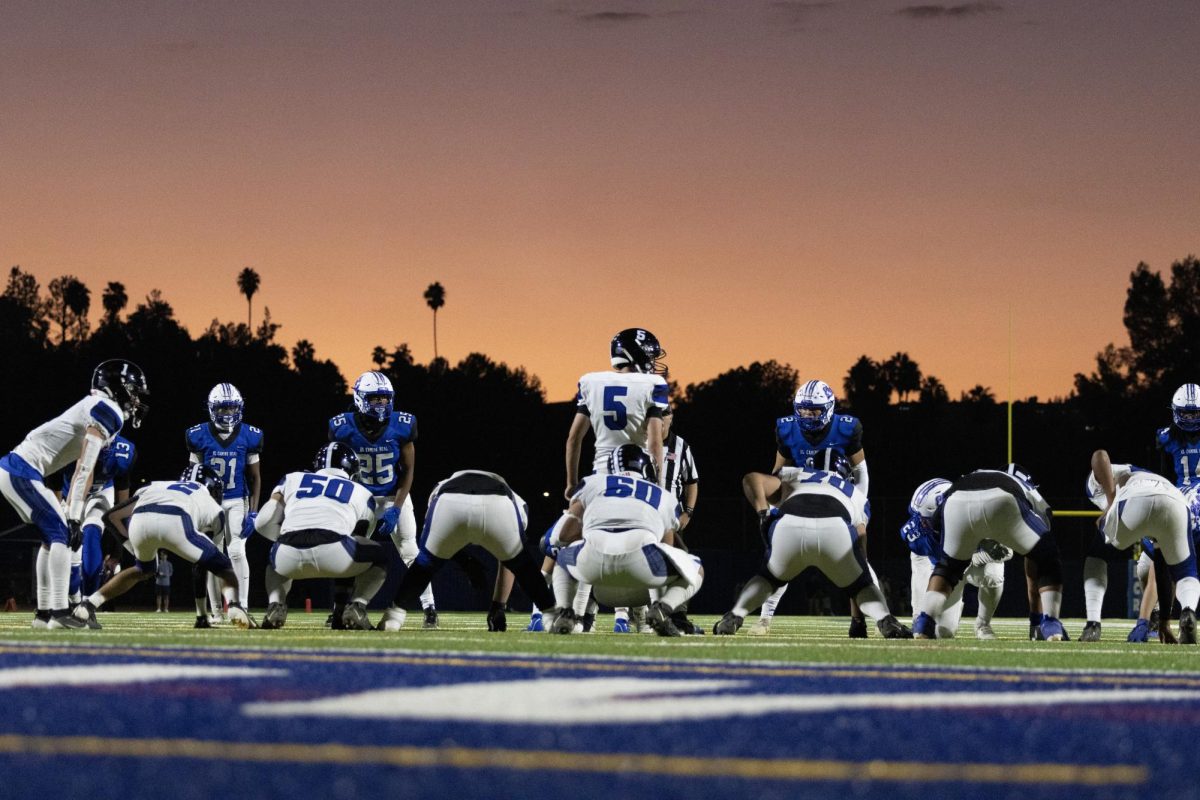 Huskies get ready for the snap as the sun sets