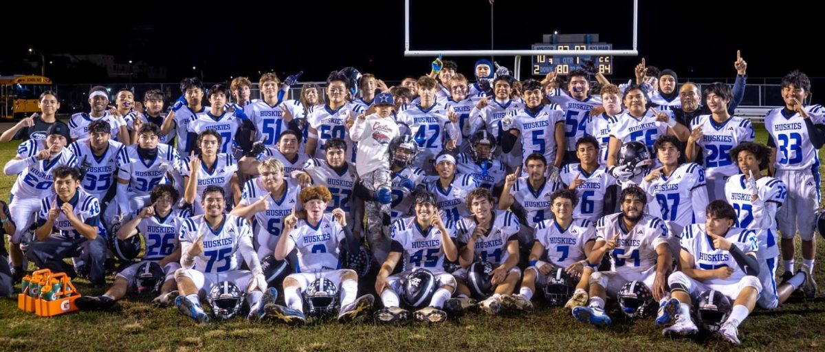 After winning the first round playoff game against Sylmar High School, North Hollywood's Varsity Boys Football team gathers to take a celebratory photo.