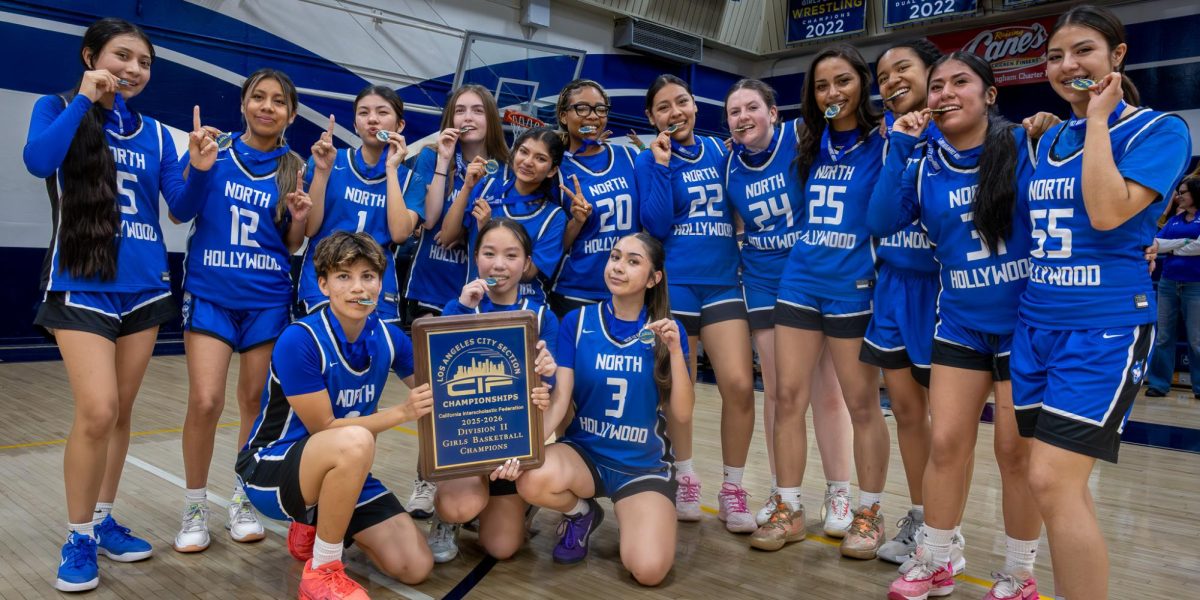 The 2025-2026 girls basketball team show off medals and D2 championship plaque with pride! 