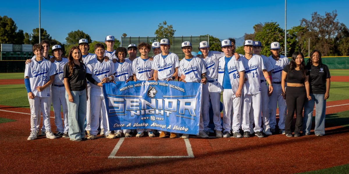 Baseball team poses for one final picture together during senior night.