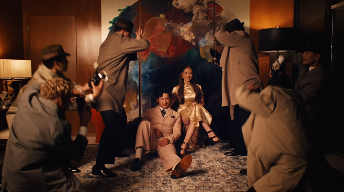 A look at Laufey’s cheongsam as she engages in a fictional photoshoot with Hudson Williams in the “Madwoman” music video. [Source: YouTube, Laufey’s “Madwoman”]